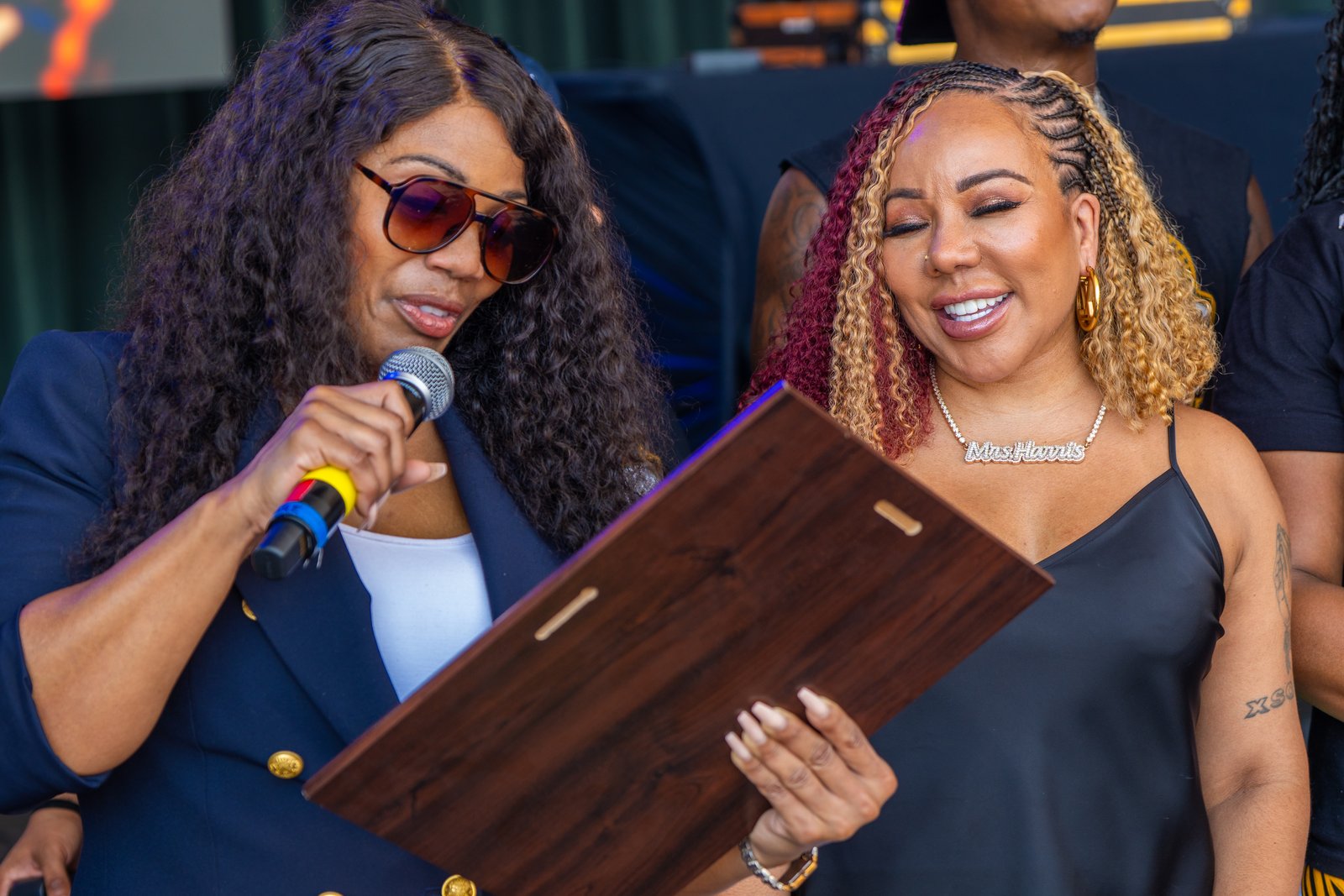 Tiny Harris receives her community award on stage at Southside Day 2026, Wolf Creek Amphitheater - photo by Di-VerZe E.N.T